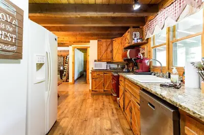 a kitchen with wooden cabinets and a white refrigerator at Roscoe Retreat in Roscoe