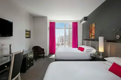a hotel room with two beds and a window at Royalton Park Avenue in New York