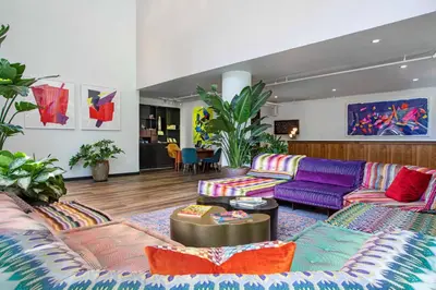 a living room with a purple couch and colorful furniture at Royalton Park Avenue in New York