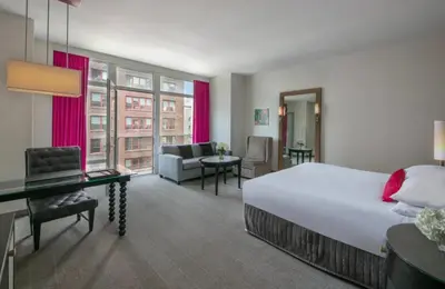 a hotel room with a large bed and a desk at Royalton Park Avenue in New York