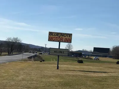a sign for a motel on the side of a road at Blue Note Motor Inn in Marietta