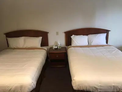 two beds sitting next to each other in a room at Blue Note Motor Inn in Marietta