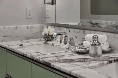 a bathroom counter with a sink and a mirror at Loews Regency New York Hotel in New York