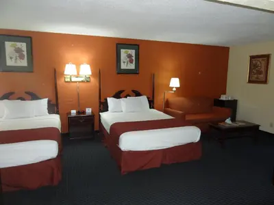 a hotel room with two beds and a couch at Red Carpet Inn Newark - Irvington NJ in Irvington