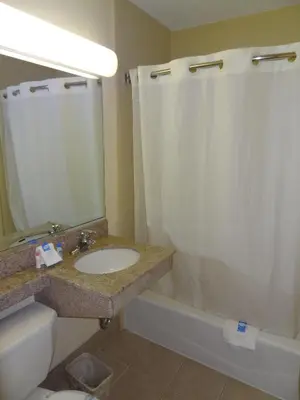 a bathroom with a sink and a toilet and a shower at Red Carpet Inn Newark - Irvington NJ in Irvington