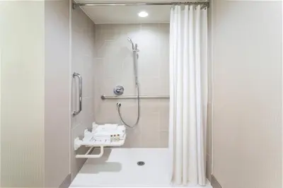 a bathroom with a shower with a shower curtain at Delta Hotels by Marriott Philadelphia Airport in Philadelphia