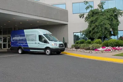 a blue van parked in front of a building at Delta Hotels by Marriott Philadelphia Airport in Philadelphia