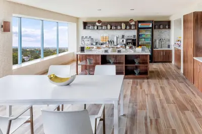 a kitchen with white tables and white chairs at Delta Hotels by Marriott Philadelphia Airport in Philadelphia