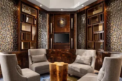 a lobby with chairs and a tv and a table at Delta Hotels by Marriott Philadelphia Airport in Philadelphia