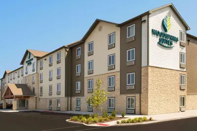a building with a sign on the side of it at WoodSpring Suites South Plainfield in South Plainfield