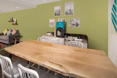 a kitchen with a table and chairs in a room at WoodSpring Suites South Plainfield in South Plainfield