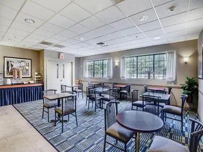 a restaurant with tables and chairs in a room at Red Carpet INN Whippany in Whippany