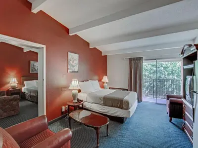 a hotel room with two beds and a balcony at Red Carpet INN Whippany in Whippany