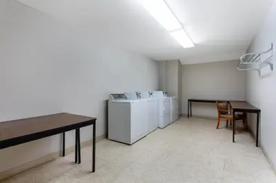 a laundry room with a washing machine and a table at Microtel Inn & Suites by Wyndham Philadelphia Airport in Philadelphia