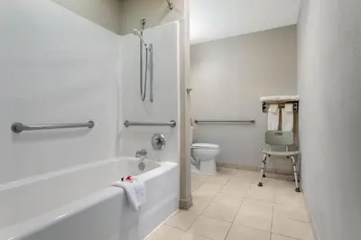 a bathroom with a bath tub and a toilet at Microtel Inn & Suites by Wyndham Philadelphia Airport in Philadelphia