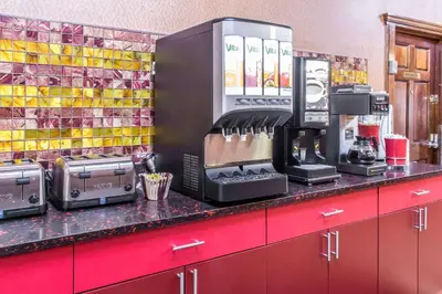 a kitchen counter with a coffee maker and appliances at Rodeway Inn Capri in Little Ferry