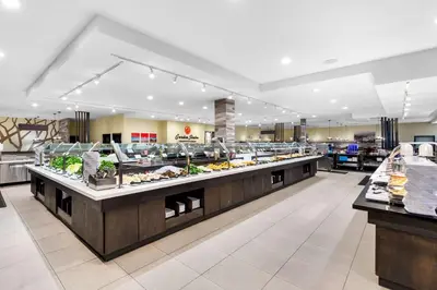 a buffet line in a restaurant with food on display at Rodeway Inn Capri in Little Ferry