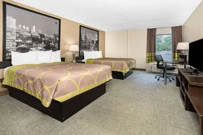 a hotel room with two beds and a desk at Super 8 by Wyndham Mount Laurel in Mount Laurel