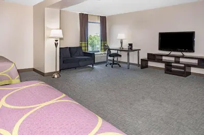 a hotel room with a bed and a flat screen tv at Super 8 by Wyndham Mount Laurel in Mount Laurel