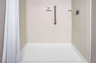 a shower with a white shower curtain in a bathroom at Super 8 by Wyndham Mount Laurel in Mount Laurel