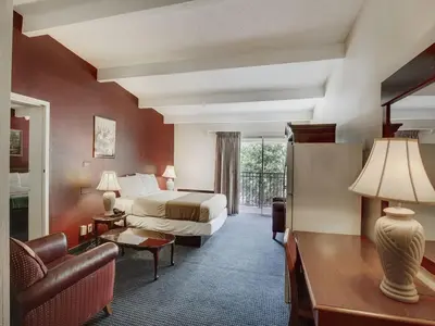 a hotel room with a bed and a couch at Scottish Inn Whippany in Whippany