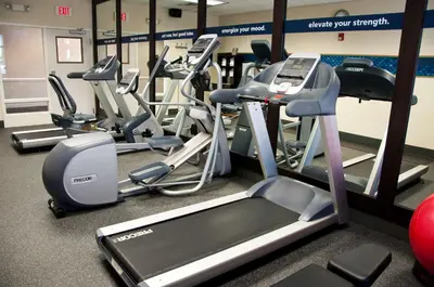 a gym with a bunch of treadmills and ellipticals at Hampton Inn Doylestown in Warrington
