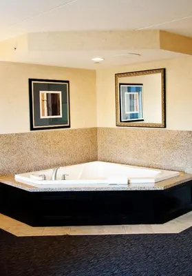 a large bath tub in a room with two mirrors at Hampton Inn Doylestown in Warrington