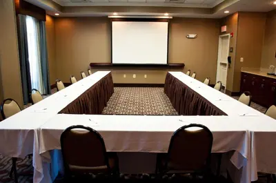 a conference room with a long table and a screen at Hampton Inn Doylestown in Warrington
