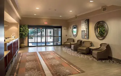 a waiting room with couches and a waiting area with a waiting room at Hampton Inn Doylestown in Warrington