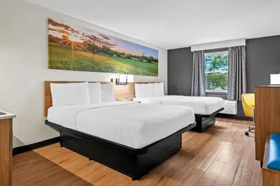 a hotel room with two beds and a window at Days Inn by Wyndham Lancaster PA Dutch Country in Ronks