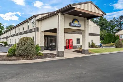 a mobil gas station with a red phone booth at Days Inn by Wyndham Lancaster PA Dutch Country in Ronks