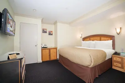 a hotel room with a bed and a flat screen tv at Hotel Mulberry in New York