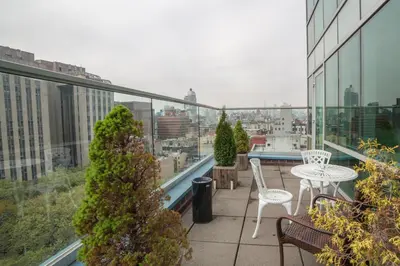 a balcony with a table and chairs on a building at Hotel Mulberry in New York