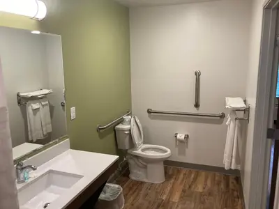 a bathroom with a toilet and a sink at Woodspring Suites Cherry Hill in Cherry Hill