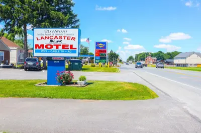 a sign for a motel on the side of a road at The Lancaster Motel By OYO Ronks near Paradise in Ronks