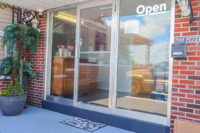 a store window with a reflection of a car in it at The Lancaster Motel By OYO Ronks near Paradise in Ronks