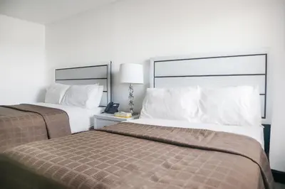 a hotel room with two beds and a lamp at The Lancaster Motel By OYO Ronks near Paradise in Ronks