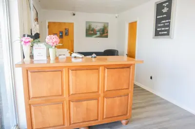a wooden dresser in a room with flowers on it at The Lancaster Motel By OYO Ronks near Paradise in Ronks