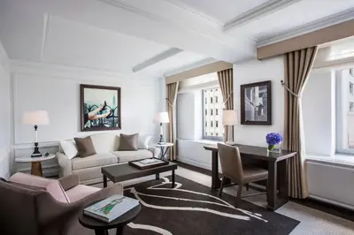 a living room with a couch and a table at The Ritz-Carlton New York, Central Park in New York