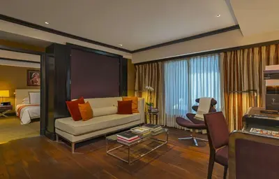 a living room with a couch and a bed at The Chatwal, The Unbound Collection by Hyatt in New York
