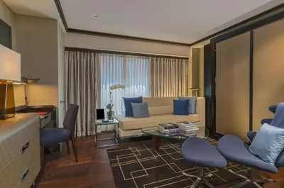 a living room with a couch and chairs and a table at The Chatwal, The Unbound Collection by Hyatt in New York