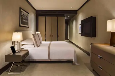 a bedroom with a large white bed and a television at The Chatwal, The Unbound Collection by Hyatt in New York