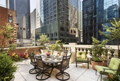 a patio with a table and chairs on a balcony at The Chatwal, The Unbound Collection by Hyatt in New York