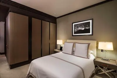 a bedroom with a large white bed with two lamps at The Chatwal, The Unbound Collection by Hyatt in New York