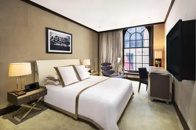 a bedroom with a large white bed and a television at The Chatwal, The Unbound Collection by Hyatt in New York