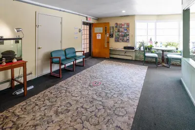 a waiting room with two chairs and a table at Buena Vista Inn Motel in Delhi