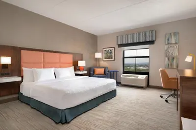 a hotel room with a bed and a desk and a window at Hampton Inn & Suites Wilkes-Barre in Wilkes-Barre