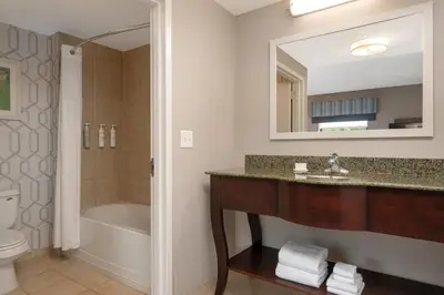 a bathroom with a sink and a tub and a toilet at Hampton Inn & Suites Wilkes-Barre in Wilkes-Barre
