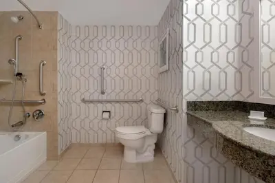 a bathroom with a toilet and a tub and a sink at Hampton Inn & Suites Wilkes-Barre in Wilkes-Barre