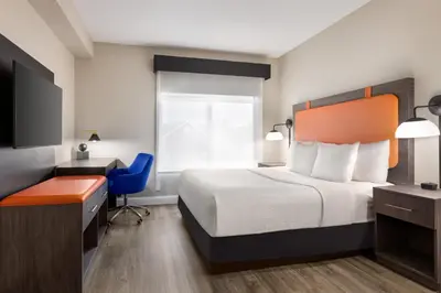 a hotel room with a bed and a desk and a chair at La Quinta by Wyndham Mt. Laurel - Philadelphia in Mount Laurel